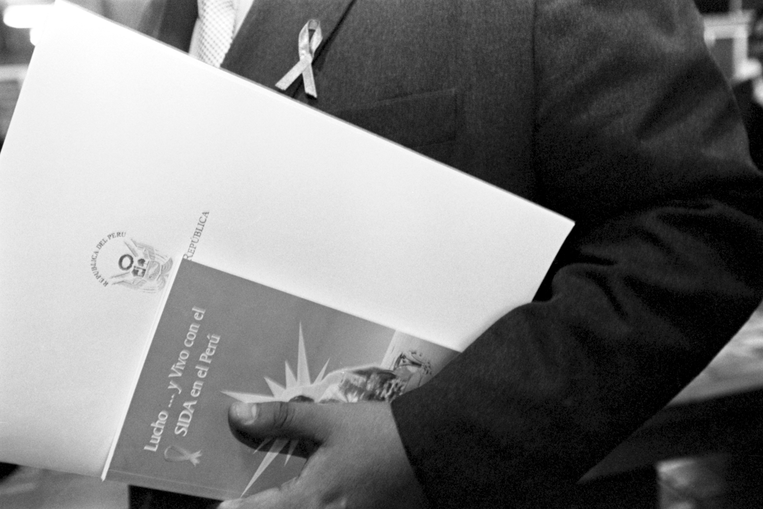 Noviembre, 1998.Un miembro del Parlamento peruano sostiene una edición del libro de Lucho Jara “Lucho y vivo con el Sida” luego de la ceremonia de lanzamiento del libro.